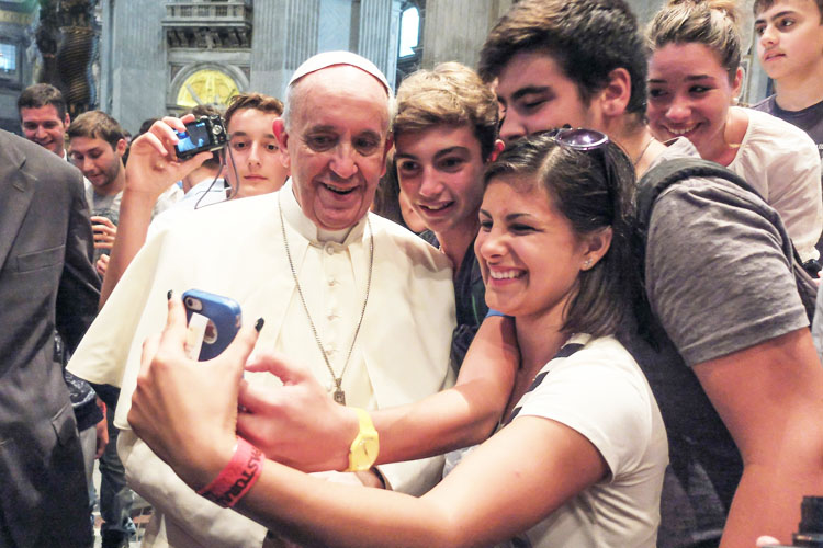 Folks taking a selfie with the pope